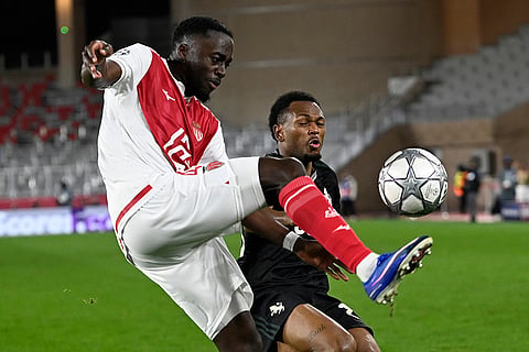 Monaco's Jordan Teze, left, and Juventus' Lois Openda challenge for the ball during the Champions League opening phase soccer match between Monaco and Juventus in Monaco.