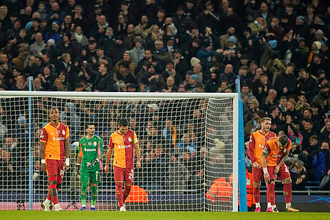Galatasaray players react after Manchester City scored their second goal during the Champions League opening phase soccer match Manchester City and Galatasaray in Manchester, England.