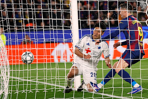 Barcelona's Robert Lewandowski scores his side's first goal during the Champions League opening phase soccer match between Barcelona and Copenhagen in Barcelona, Spain.