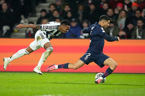 PSG's Achraf Hakimi, right, chased by Newcastle's Joe Willock during a Champions League opening phase soccer match between Paris Saint-Germain and Newcastle in Paris.