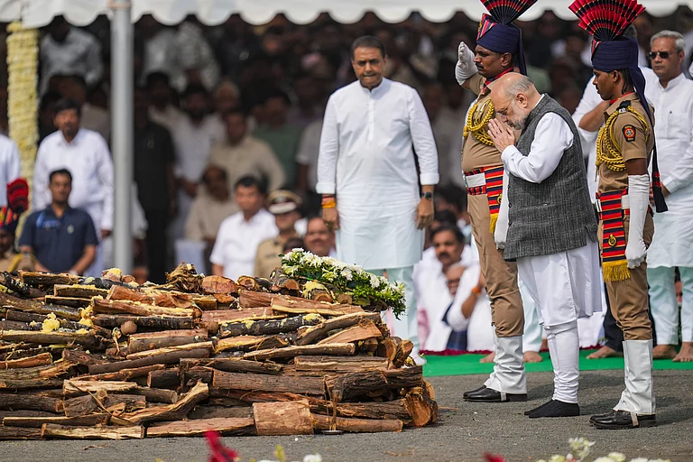 Union Home Minister Amit Shah pays last respects to the mortal remains of Maharashtra Deputy Chief Minister Ajit Pawar during his funeral at the Vidya Pratishthan ground at Baramati, in Pune district. - PTI