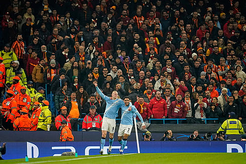 Manchester City's Erling Haaland, left, celebrates with Omar Marmoush after scoring the opening goal during the Champions League opening phase soccer match Manchester City and Galatasaray in Manchester, England.
