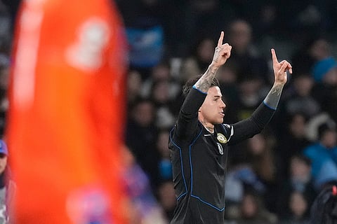 Chelsea's Enzo Fernandez celebrates after scoring his side's first goal on a penalty kick during a Champions League opening phase soccer match between Napoli and Chelsea, in Naples, Italy.