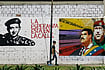 Where Roses Bloom In The Shadow of Oil Politics | Photo: Imago/Zuma Press Wire : Leaders on the Wall: A man walks past grafitti in Valencia city, Venezuela, depicting Nicolás Maduro, Simón Bolivar and Hugo Chávez
