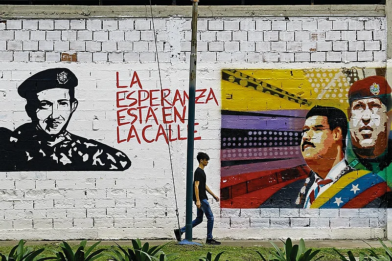 A man walks past grafitti in Valencia city, Venezuela.
