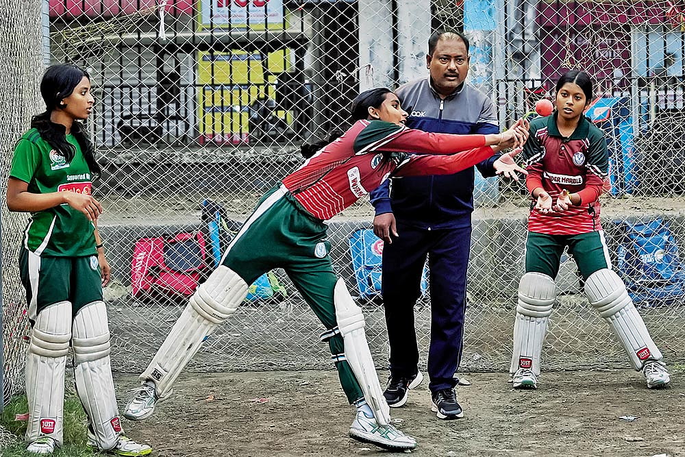 Gopal Saha, the childhood coach of Richa Ghosh, during a practice session