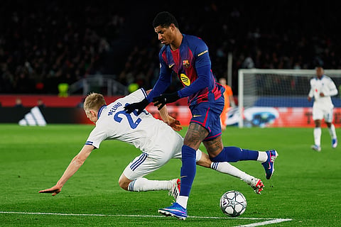 Copenhagen's Birger Meling fights for the ball against Barcelona's Marcus Rashford during the Champions League opening phase soccer match between Barcelona and Copenhagen in Barcelona, Spain.