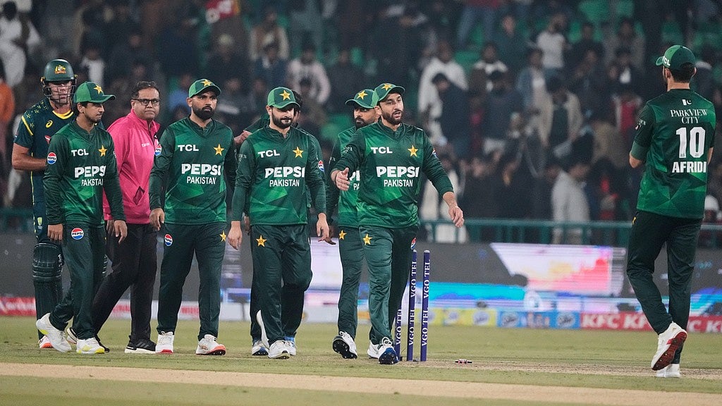 Photo: AP : Pakistan's Salman Ali Agha, second right, and teammates walk off the field on the end of the first T20 cricket match between Pakistan and Australia, in Lahore.