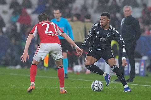 Real Madrid's Kylian Mbappe, right, vies for the ball with Benfica's Andreas Schjelderup during a Champions League opening phase soccer match between Benfica and Real Madrid, in Lisbon.