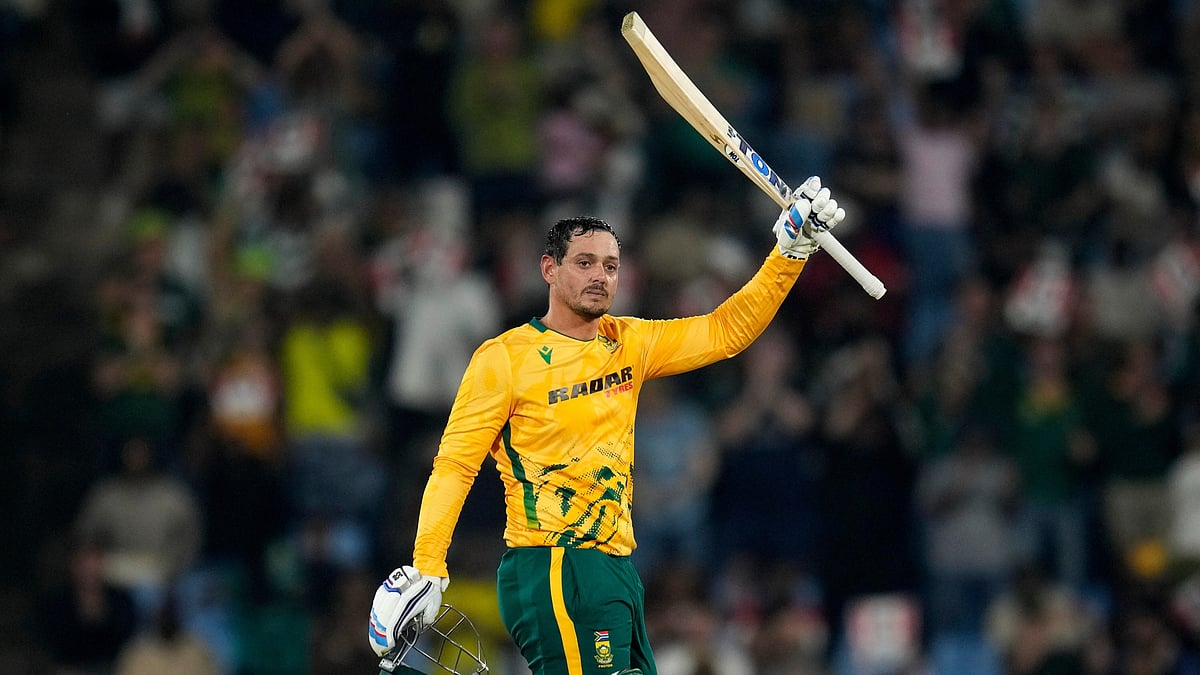 (AP Photo/Themba Hadebe) : South Africa's batsman Quinton de Kock raises his bat after reaching a century during the T20 International cricket match between South Africa and West Indies, in Centurion, South Africa, Thursday, Jan. 29, 2026.
