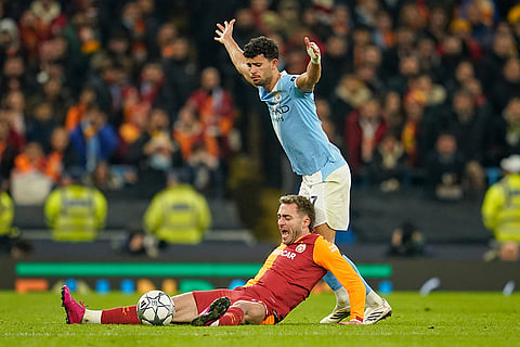 Manchester City's Matheus Nunes, right, challenges Galatasaray's Baris Yilmaz during the Champions League opening phase soccer match Manchester City and Galatasaray in Manchester, England.
