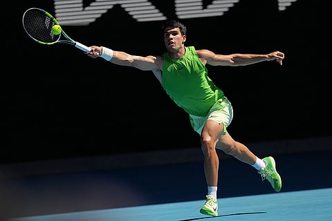 Carlos Alcaraz of Spain plays a forehand return to Alexander Zverev of Germany during their semifinal match at the Australian Open tennis championship in Melbourne, Australia.