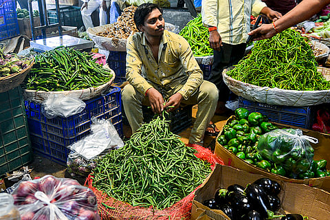 A vendor checks an UPI payment made by a customer, ahead of the presentation of the Union Budget 2026-27 by Union Finance Minister Nirmala Sitharaman, at a market, in Navi Mumbai.