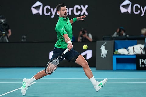 Novak Djokovic of Serbia plays a forehand return to Jannik Sinner of Italy during their semifinal match at the Australian Open tennis championship in Melbourne, Australia.