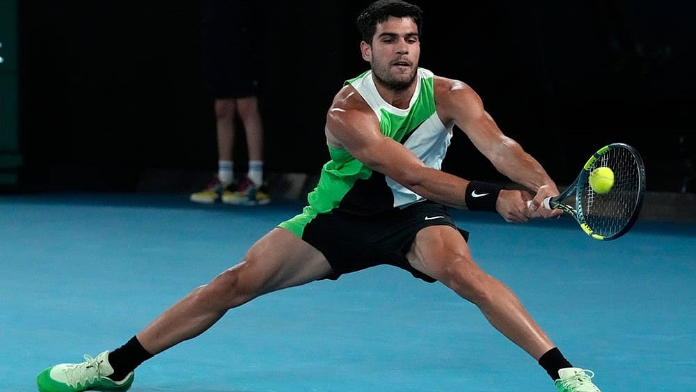 | Photo: AP/Asanka Brendon Ratnayake : Carlos Alcaraz of Spain plays a backhand return to Alex de Minaur of Australia during their quarterfinal match at the Australian Open tennis championship in Melbourne, Australia.