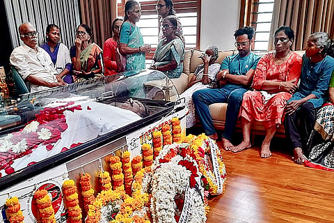 Indian Olympic Association (IOA) President PT Usha with family members and others waits near the mortal remains of her husband V Srinivasan after he passed away, at his residence, in Kozhikode, Kerala.