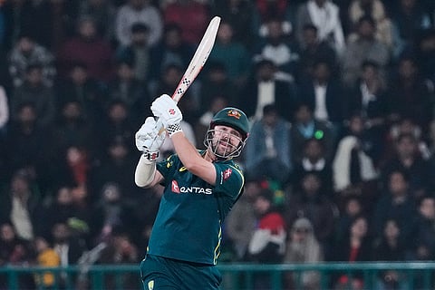 Australia's Travis Head follows the ball after playing a shot for boundary during the first T20 cricket match between Pakistan and Australia, in Lahore, Pakistan.