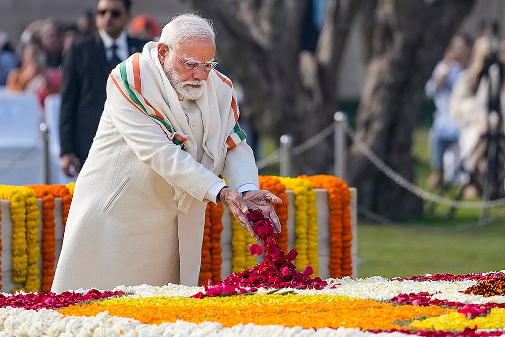 | Photo: PTI/Ravi Choudhary : Prime Minister Narendra Modi pays tribute to Mahatma Gandhi at Rajghat on the occasion of Martyrs' Day, observed to mark the death anniversary of the father of the nation, in New Delhi.