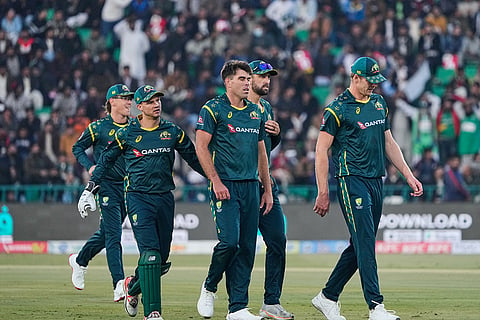 Australia's Xavier Bartlett, center, celebrates with teammates after the dismissal of Pakistan's Fakhar Zaman during the first T20 cricket match between Pakistan and Australia, in Lahore, Pakistan.