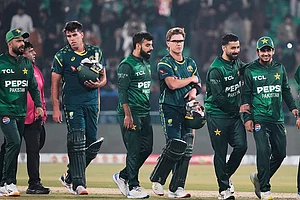 | Photo: AP/K.M. Chaudary : Australia's Xavier Bartlett, second left, and Adam Zampa, third right, and Pakistani players walk off the field on the end of the first T20 cricket match between Pakistan and Australia, in Lahore, Pakistan.