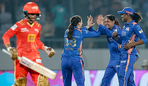Mumbai Indians’ Amelia Kerr, back left, celebrates with captain Harmanpreet Kaur, back centre, and Hayley Matthews, right, after taking the wicket of Gujarat Giants’ captain Anushka Sharma during a Women's Premier League (WPL) 2026 T20 International cricket match between Gujarat Giants and Mumbai Indians, at BCA Stadium, in Vadodara, Gujarat. 