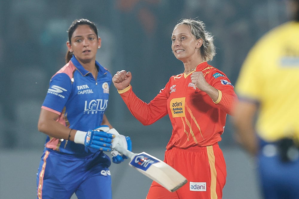 | Photo: BCCI via PTI : Gujarat Giants' captain Ashleigh Gardner, right, celebrates after winning a Women's Premier League (WPL) 2026 T20 International cricket match between Gujarat Giants and Mumbai Indians, at BCA Stadium, in Vadodara, Gujarat. Mumbai Indians’ captain Harmanpreet Kaur is also seen. 
