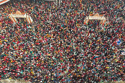 Devotees gather at a camp to listen to spiritual leader Pradeep Mishra, unseen, on the eve of the 'Maghi Purnima' festival, in Prayagraj.