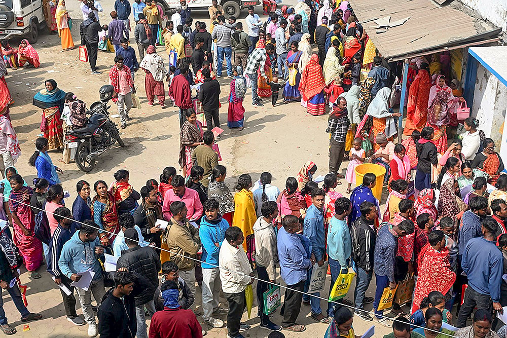 | Photo: PTI : People wait in queues outside a camp during hearings under the Special Intensive Revision (SIR) of electoral rolls, in Malda, West Bengal.