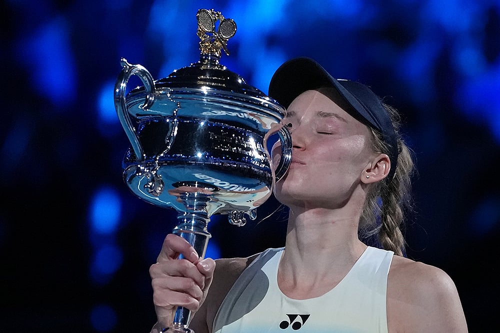 | Photo: AP/Aaron Favila : Elena Rybakina of Kazakhstan kisses the Daphne Akhurst Memorial Cup after defeating Aryna Sabalenka of Belarus to win the women's singles final at the Australian Open tennis championship in Melbourne, Australia.