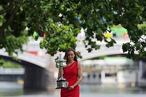 Elena Rybakina of Kazakhstan poses with Daphne Akhurst Memorial Cup on the banks of the Yarra River the morning after defeating Aryna Sabalenka of Belarus in the women's singles final at the Australian Open tennis championship in Melbourne, Australia.