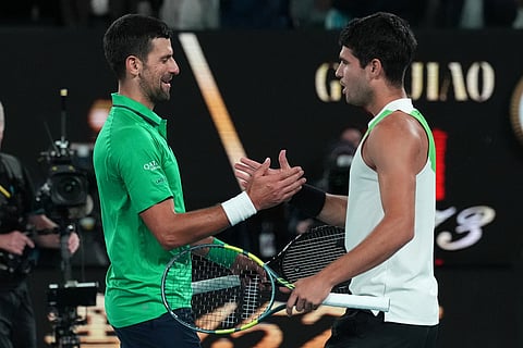 Carlos Alcaraz, right, of Spain is congratulated by Novak Djokovic, left, of Serbia after winning the men's singles final at the Australian Open tennis championship in Melbourne, Australia.