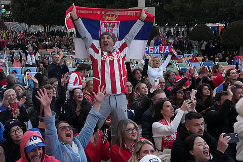 Supporters of Novak Djokovic of Serbia react as they watch his match on a screen against Carlos Alcaraz of Spain during the men's singles final at the Australian Open tennis championship in Melbourne, Australia.