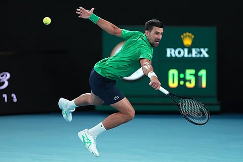 Novak Djokovic of Serbia plays a backhand return to Carlos Alcaraz of Spain during the men's singles final at the Australian Open tennis championship in Melbourne, Australia.