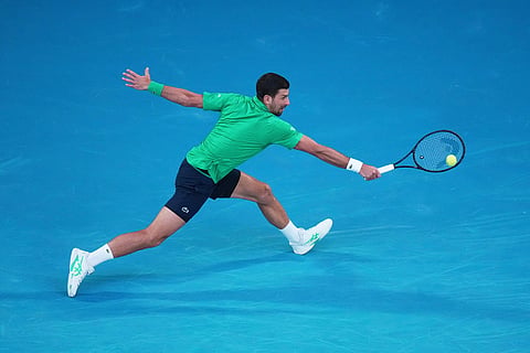 Novak Djokovic of Serbia plays a backhand return to Carlos Alcaraz of Spain in their final match at the Australian Open tennis championship in Melbourne, Australia.