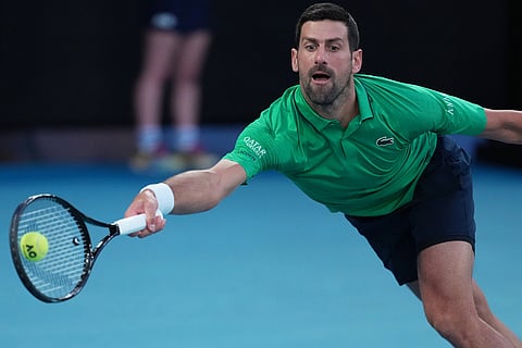 Novak Djokovic of Serbia plays a forehand to Carlos Alcaraz of Spain during the men's singles final at the Australian Open tennis championship in Melbourne, Australia.