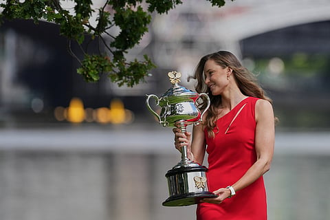Elena Rybakina of Kazakhstan poses with Daphne Akhurst Memorial Cup on the banks of the Yarra River the morning after defeating Aryna Sabalenka of Belarus in the women's singles final at the Australian Open tennis championship in Melbourne, Australia.