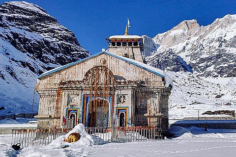 The 'Kedarnath Dham' is seen against snow-capped mountains after fresh snowfall, in Rudraprayag, Uttarakhand.