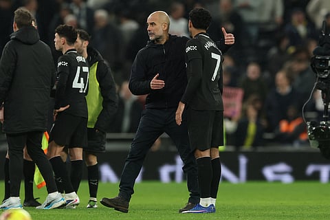 Manchester City's head coach Pep Guardiola greets Omar Marmoush after the the English Premier League soccer match between Tottenham Hotspur and Manchester City in London.