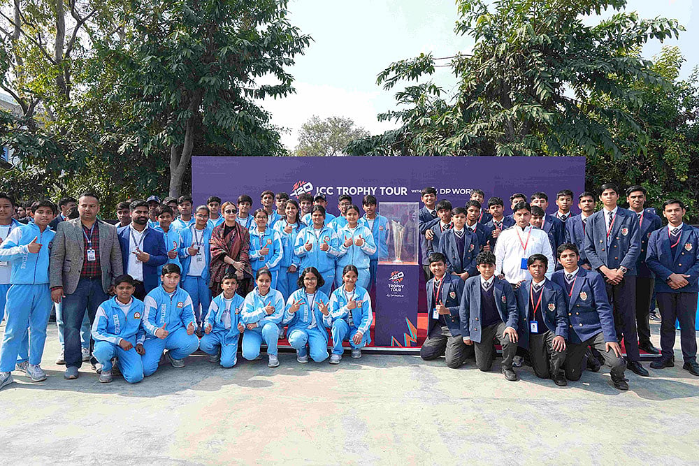 Students of Delhi Public School, Aligarh pose with the ICC Men’s T20 World Cup 2026 trophy during its visit