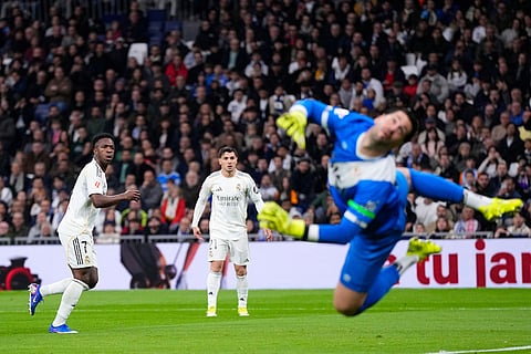 Real Madrid's Vinicius Junior scores his side's first goal during the Spanish La Liga soccer match between Real Madrid and Rayo Vallecano in Madrid, Spain.