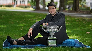| Photo: AP/Dita Alangkara : Carlos Alcaraz of Spain poses with the Norman Brookes Challenge Cup the morning after defeating Novak Djokovic of Serbia in the men's singles final at the Australian Open tennis championship, in Melbourne, Australia, Monday, Feb. 2, 2026.