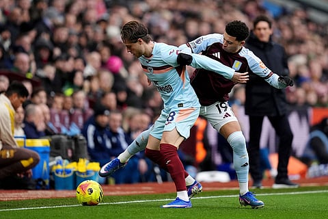 Aston Villa's Jadon Sancho, right, and Brentford's Mathias Jensen battle for the ball during their English Premier League soccer match in Birmingham, England.