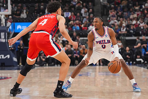 Philadelphia 76ers' Tyrese Maxey (0) is defended by Los Angeles Clippers guard Kobe Sanders (4) during the first half of an NBA basketball game in Inglewood, California.