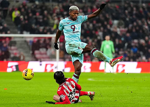 Sunderland's Enzo Le Fee, bottom, and Burnley's Luis Florentino battle for the ball during a Premier League soccer match in Sunderland.
