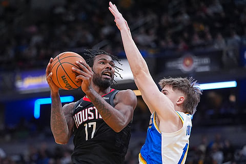 Houston Rockets forward Tari Eason (17) shoots over Indiana Pacers guard Johnny Furphy (12) during the second half of an NBA basketball game in Indianapolis.