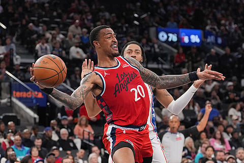 Los Angeles Clippers forward/center John Collins (20) passes the ball during the second half of an NBA basketball game against the Philadelphia 76ers in Inglewood, California. 