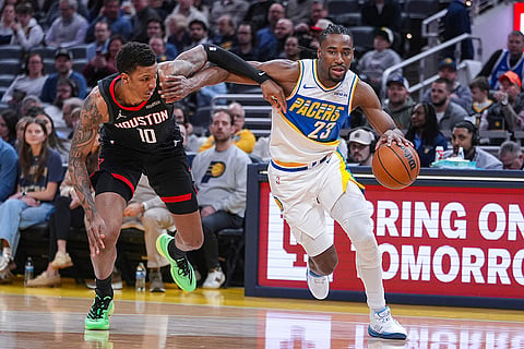 Indiana Pacers guard/forward Aaron Nesmith (23) drives on Houston Rockets forward Jabari Smith Jr. (10) during the first half of an NBA basketball game in Indianapolis.