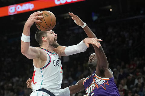 Los Angeles Clippers center Ivica Zubac, left, goes up for a shot against Phoenix Suns center Mark Williams, right, during the second half of an NBA basketball game in Phoenix. 