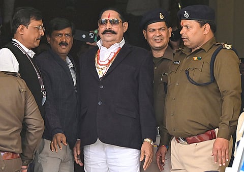 Jailed JD(U) MLA Anant Singh, centre, arrives to attend the Budget session of the Bihar Assembly, in Patna.