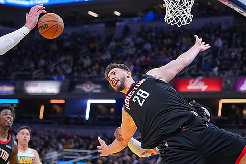 Houston Rockets center Alperen Sengun (28) is fouled from behind by Indiana Pacers forward Bennedict Mathurin (00) during the second half of an NBA basketball game in Indianapolis.